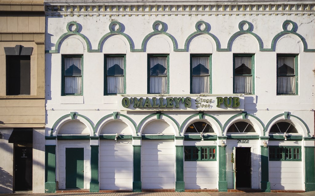 the facade of a building with a sign that reads pub