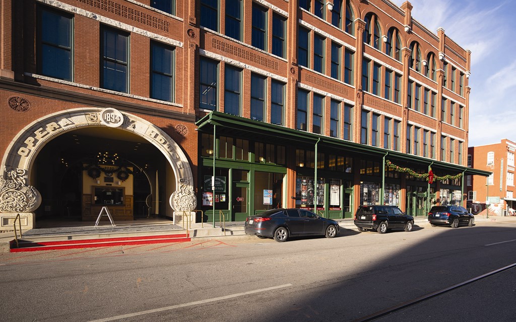 a large brick building with cars parked in front of it