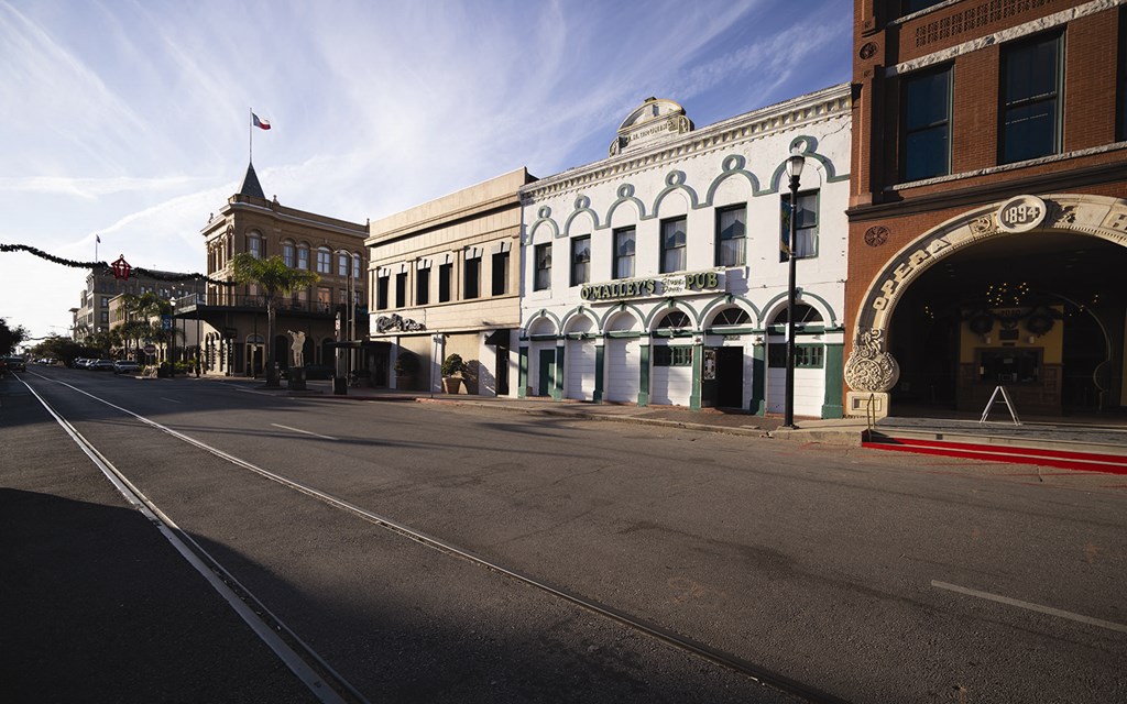 a city street with buildings on the corner of a street