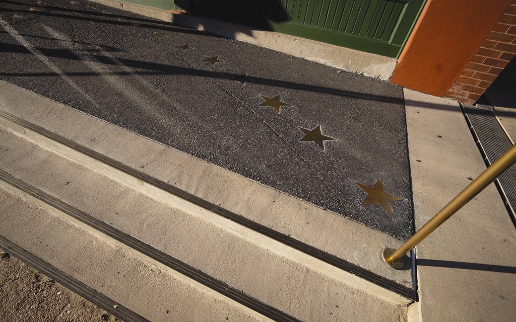 stars on the steps of a sidewalk next to stairs