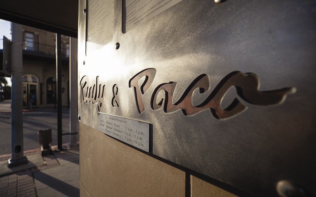 a sign on the side of a building with the name of a restaurant