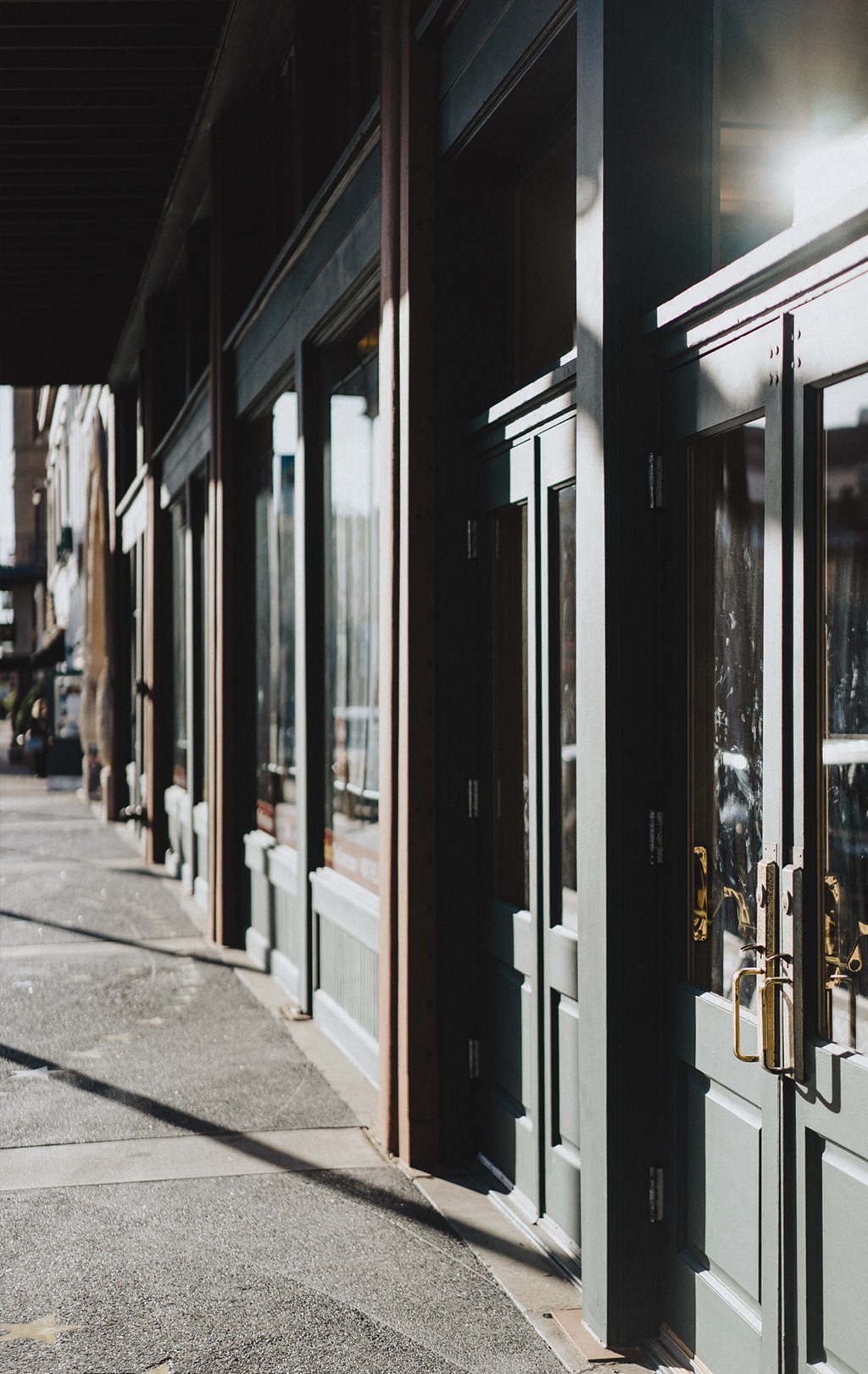 a row of store fronts on a city street at night