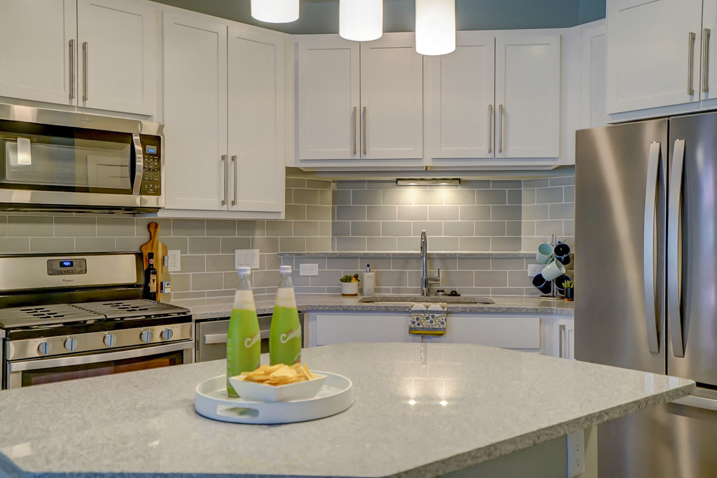a kitchen with stainless steel appliances and a counter with a plate of food on it