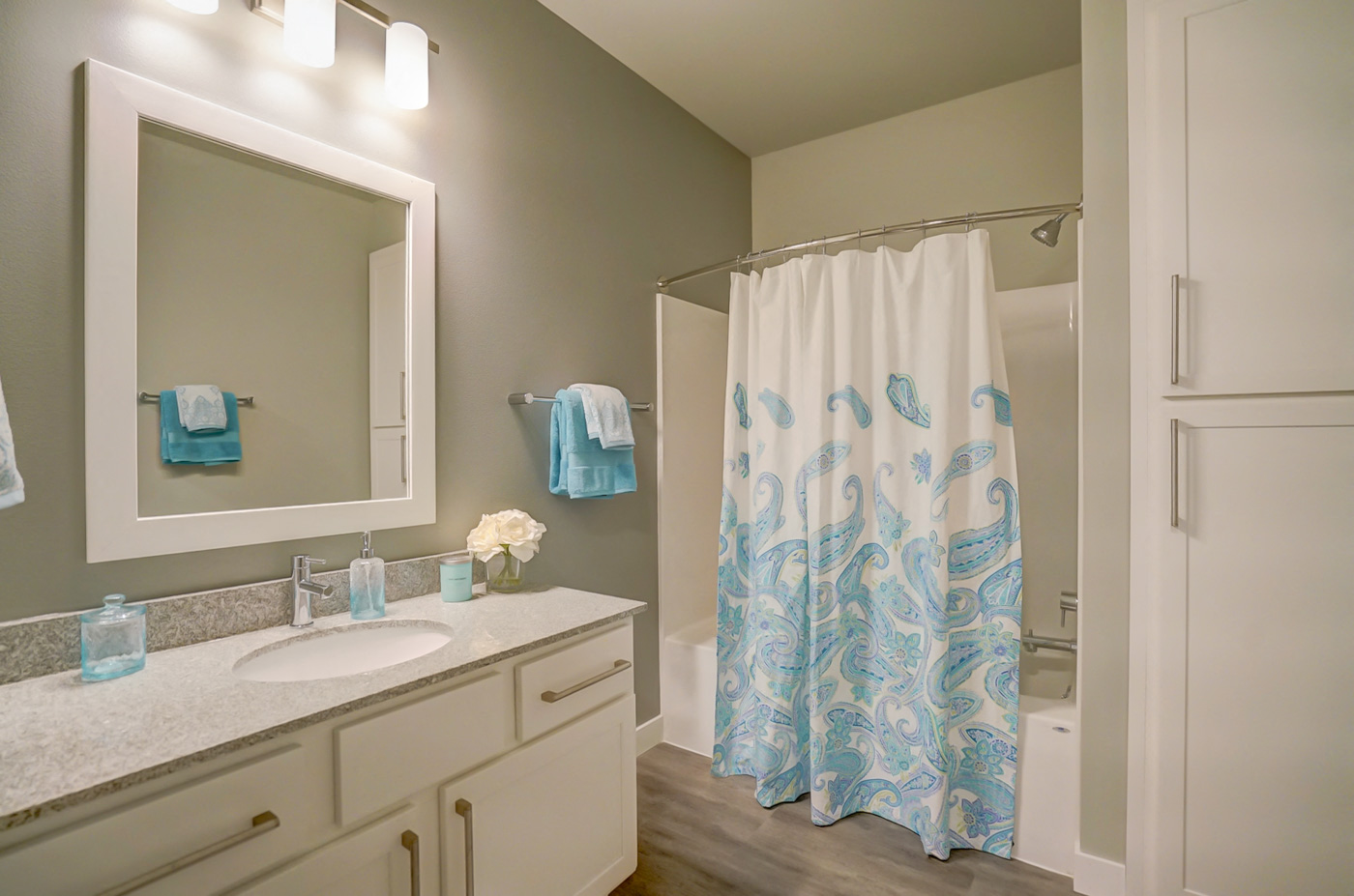 a bathroom with a shower curtain and a sink