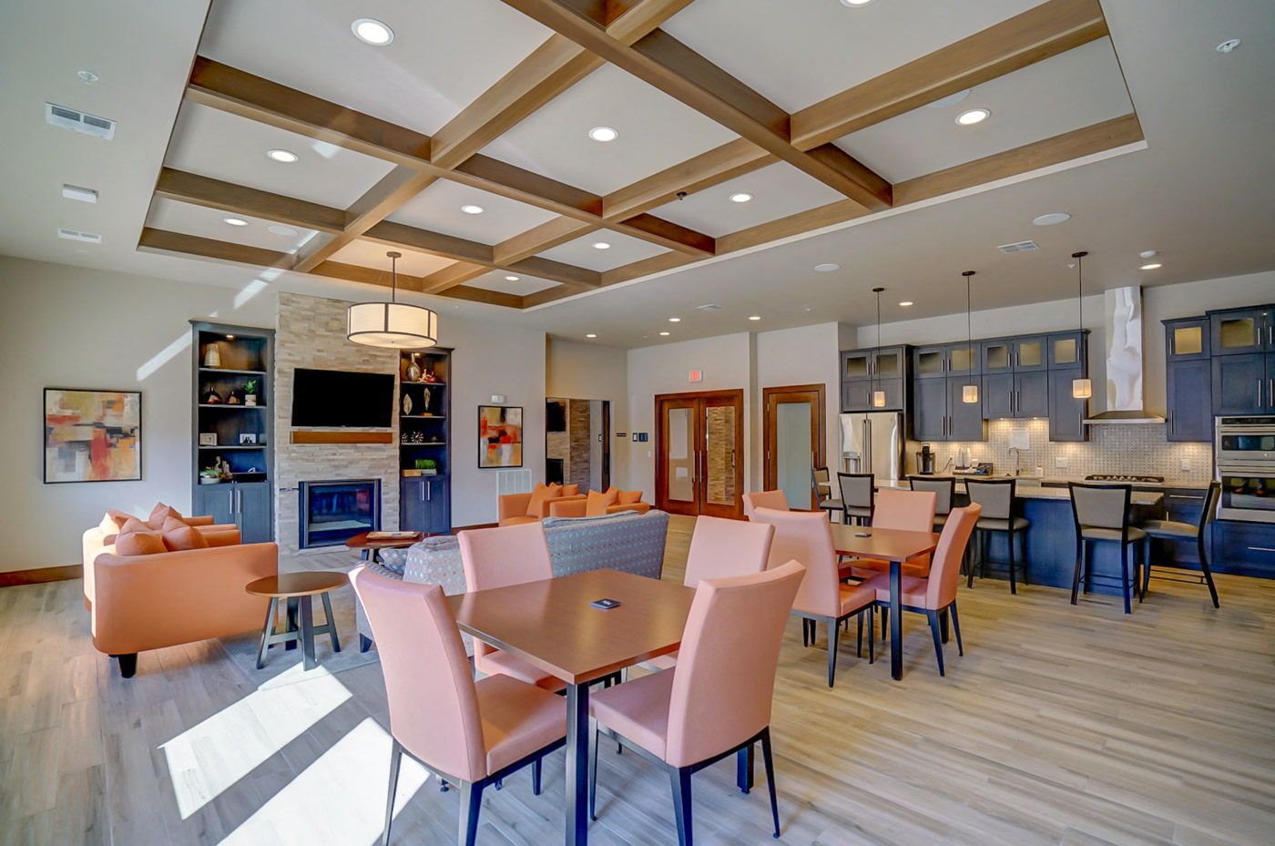 a large dining room with tables and chairs and a kitchen