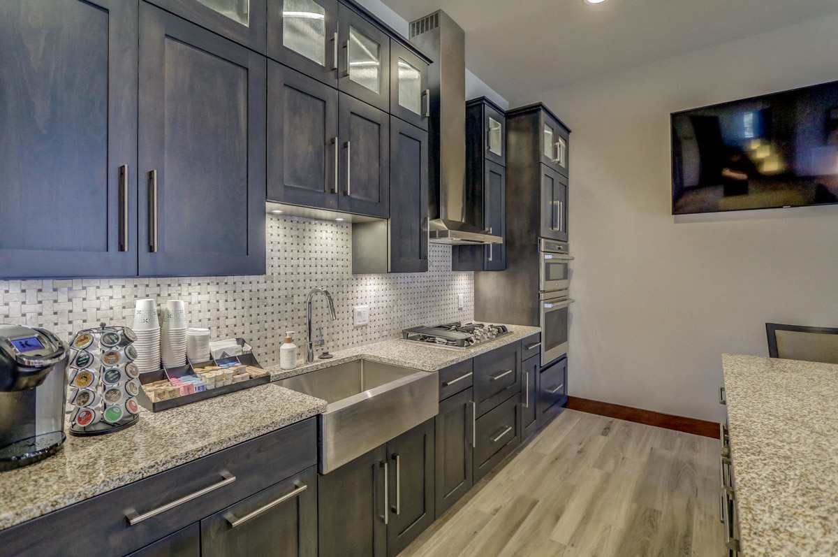 a kitchen with gray cabinets and a sink