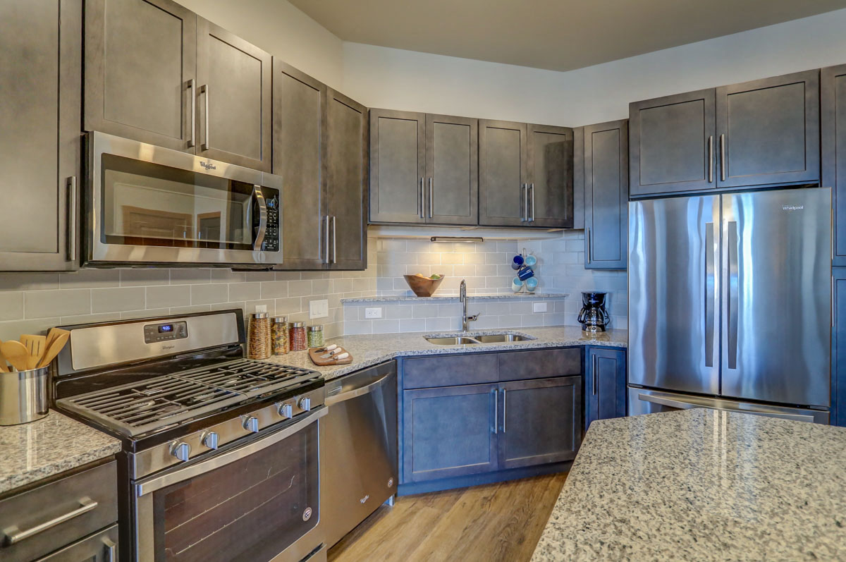 a kitchen with stainless steel appliances and granite counter tops