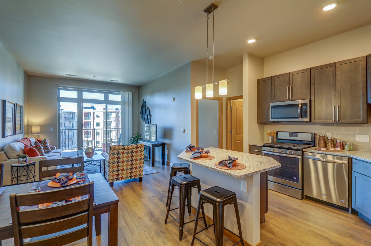 a kitchen with a center island and a living room