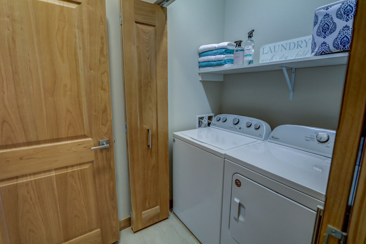 the laundry room has a washer and dryer and a door to the closet