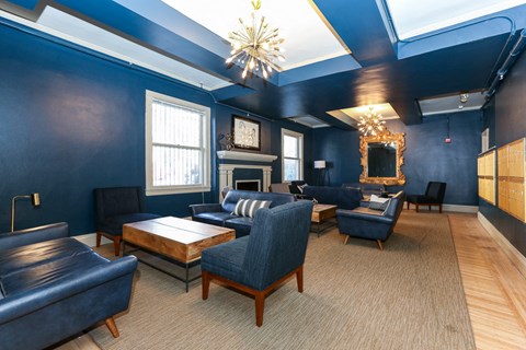 a living room with blue walls and chairs and a fireplace