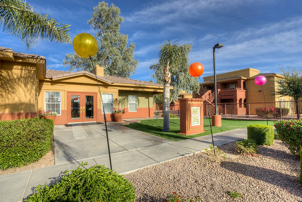 a house with a yard and balloons in front of it