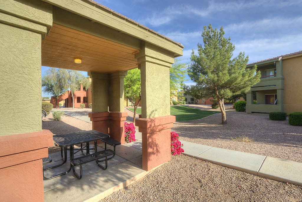 a patio with a table and a picnic table