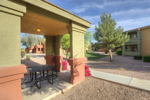a patio with a table and a picnic table