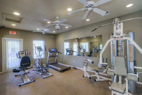 a gym with treadmills and other exercise equipment