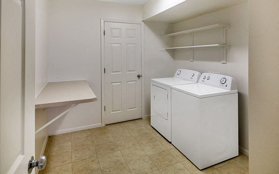 a laundry room with a washer and dryer and a closet