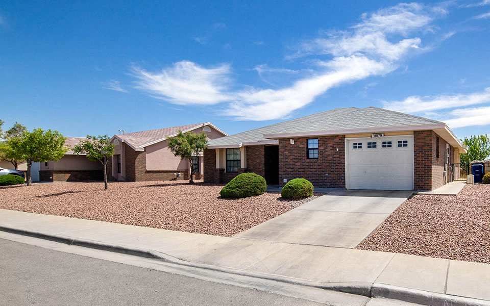a small brick house with a white garage door