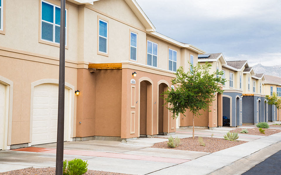 a row of houses on the side of a street