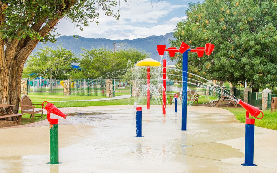 a splash park in a park with water fountains
