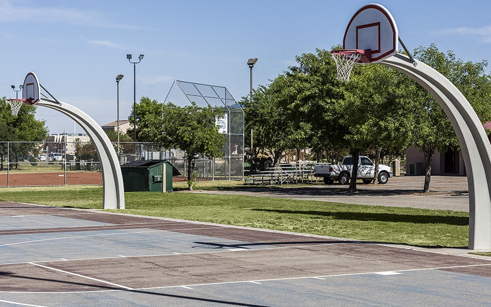 a basketball hoop on a court in a park