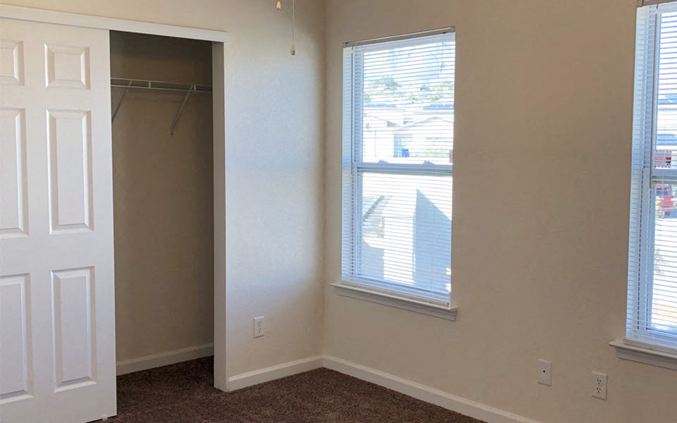 a room with a closet and a window and a door