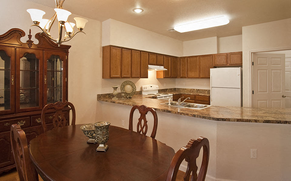 a kitchen with a wooden table and a counter top