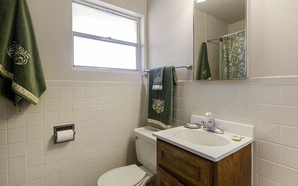 a bathroom with a toilet sink and a mirror