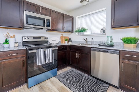 a kitchen with stainless steel appliances and wooden cabinets