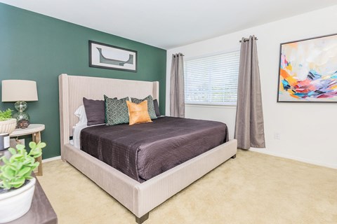 a bedroom with a bed and a large window