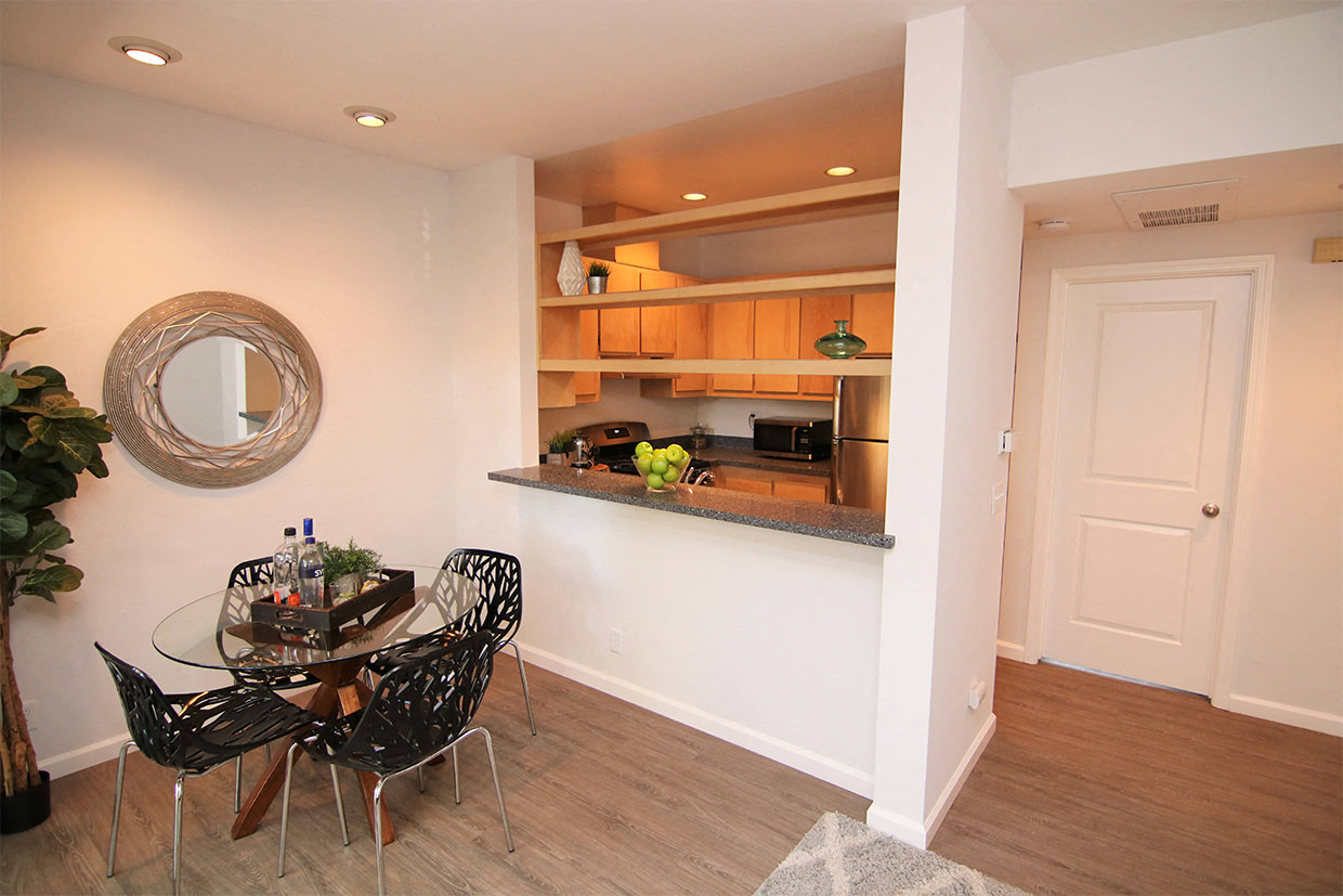 View of dining room, kitchen window, and entryway