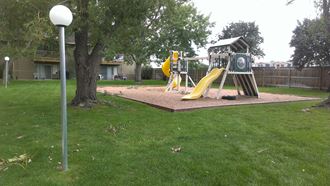 a playground with a swing set in a park