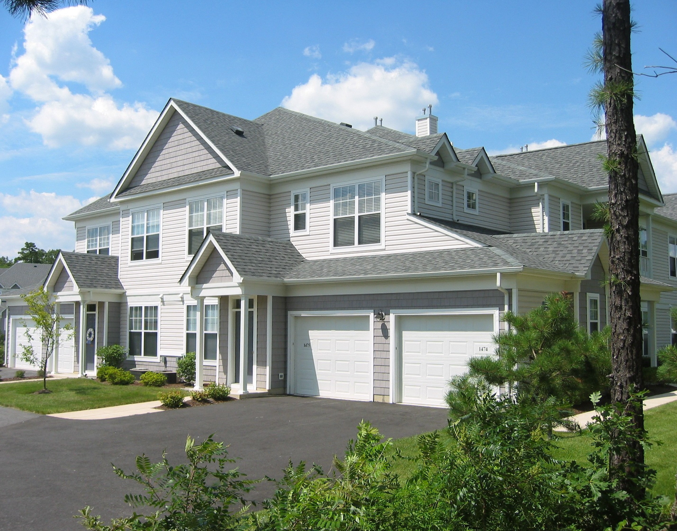 a large white house with a garage door