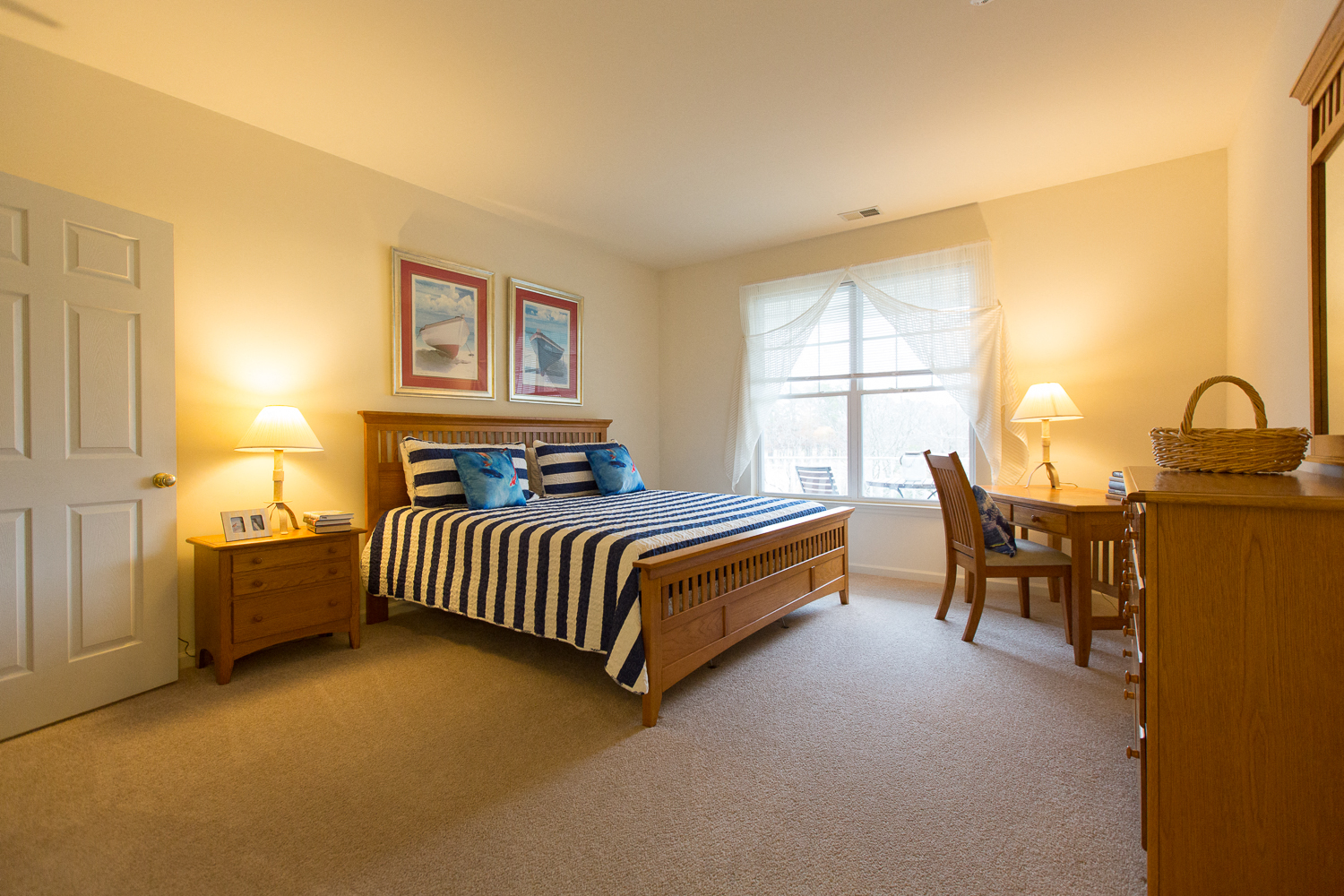 a bedroom with a bed and a desk and a window