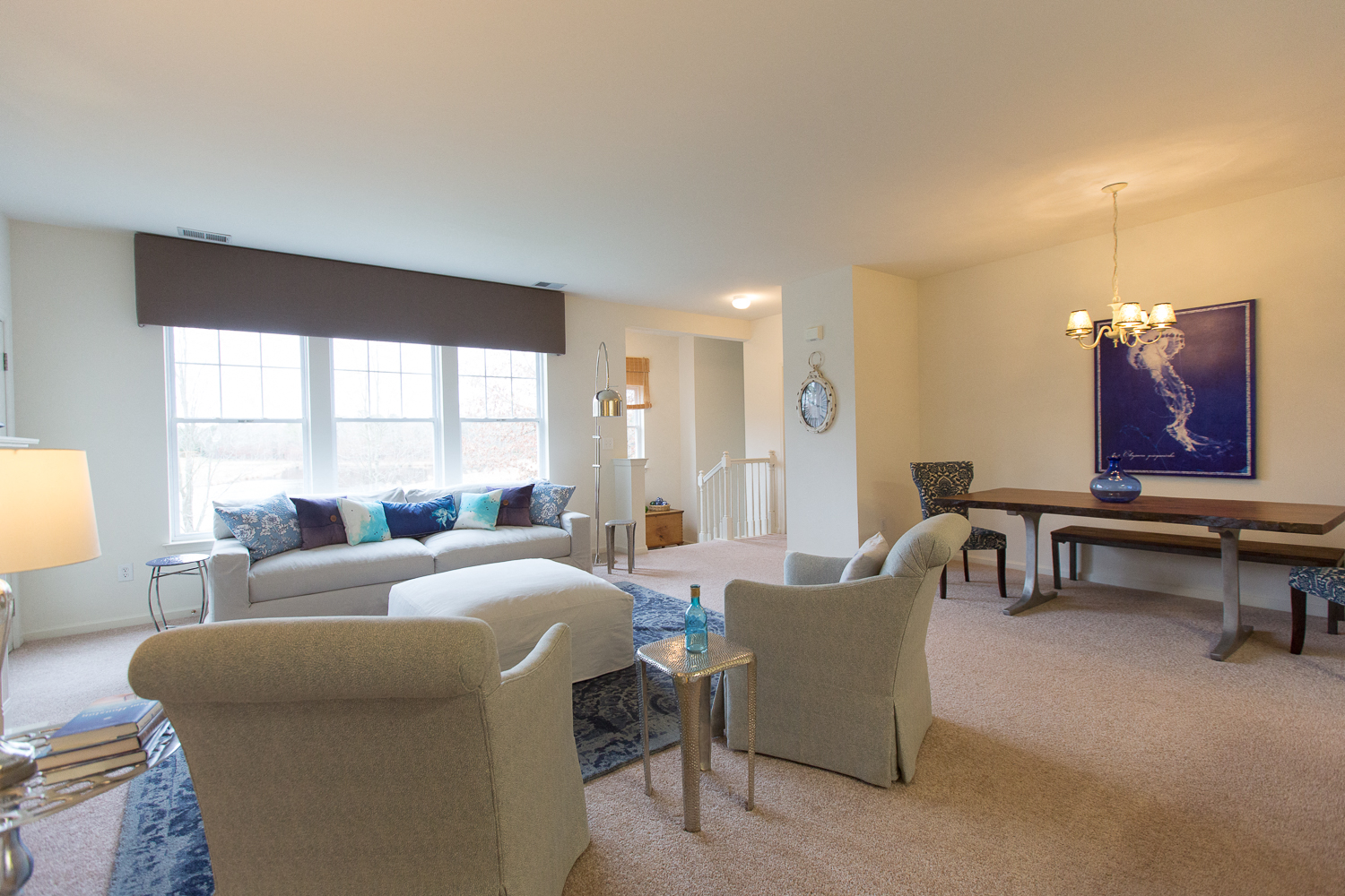a living room with couches and chairs and a piano
