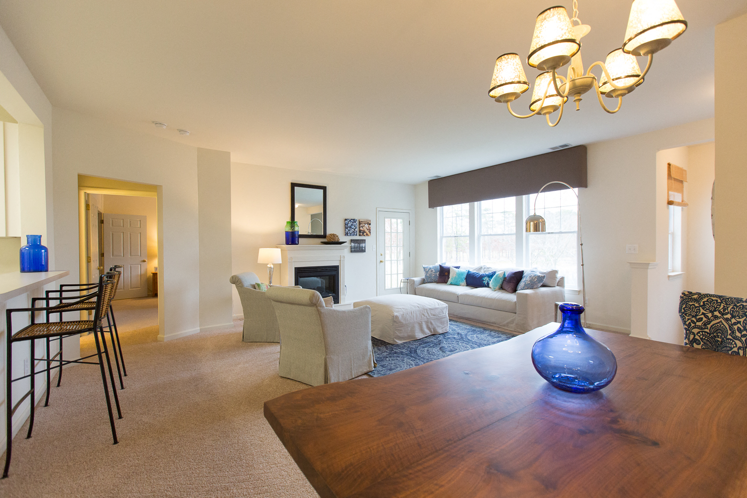 a living room and dining room with a table and chairs