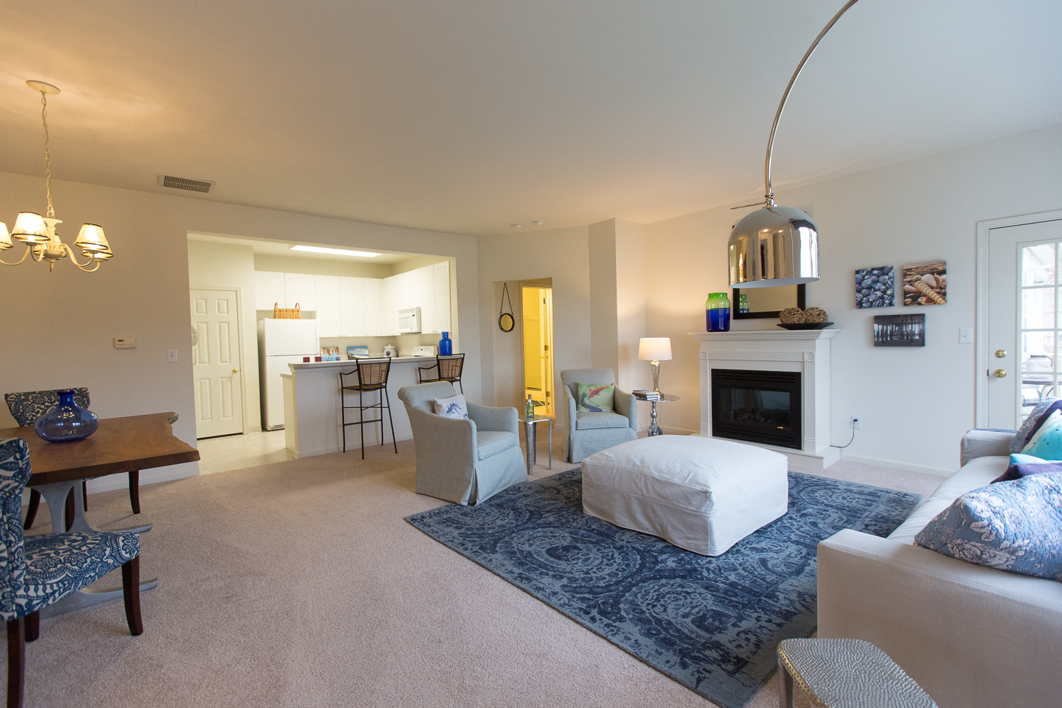 a bedroom with a bed and a living room with a kitchen