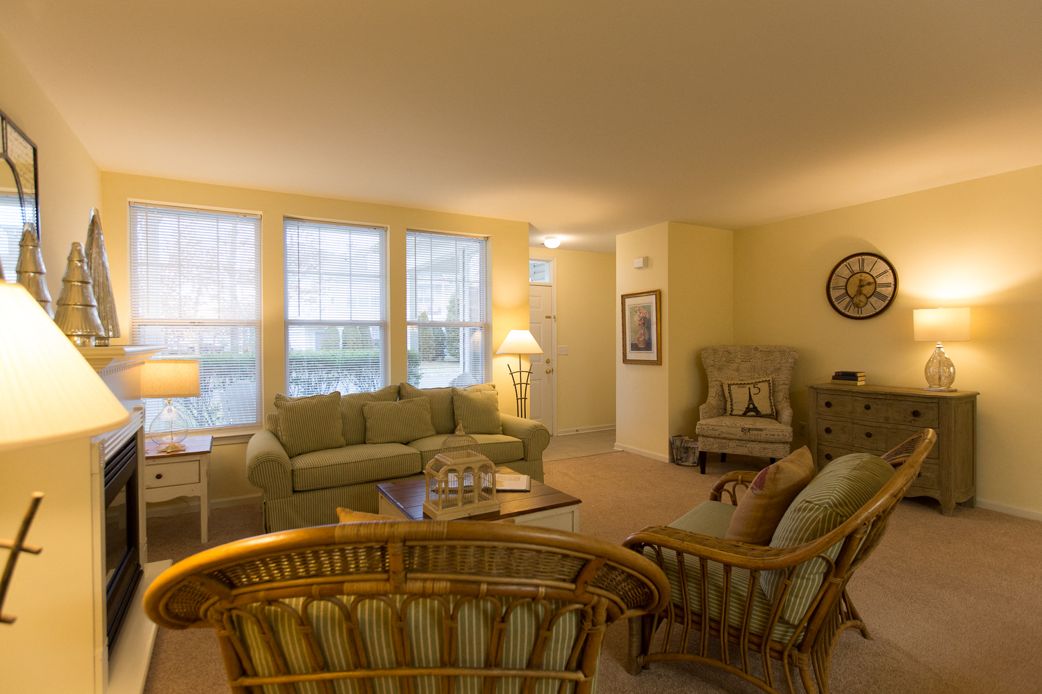 a living room with a couch and chairs and a table