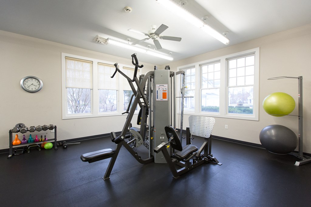 a home gym with exercise equipment and windows