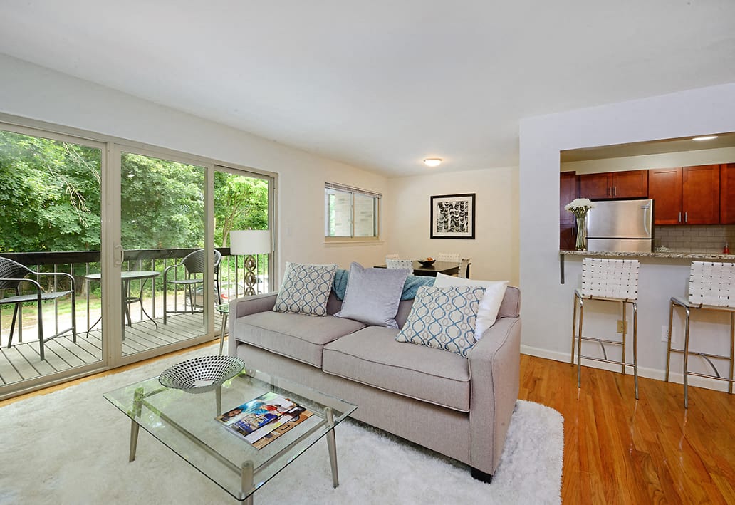 a living room with a couch and a glass table