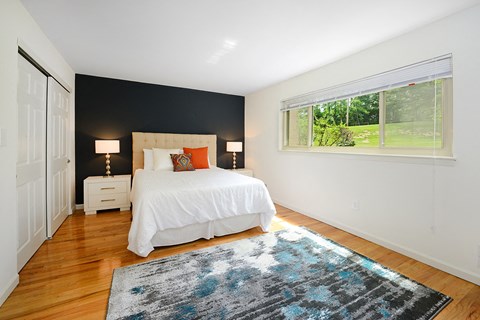 a bedroom with a bed and a window