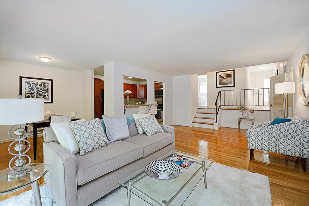 a living room with a couch and a glass coffee table