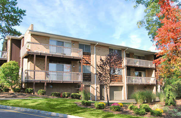the exterior of an apartment building with balconies and trees