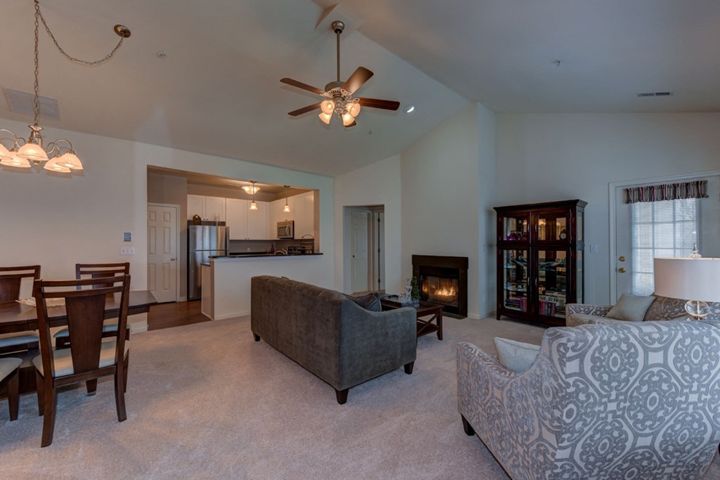a living room with a couch and a table and a fireplace