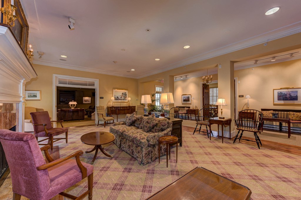 a living room with couches and chairs and a fireplace