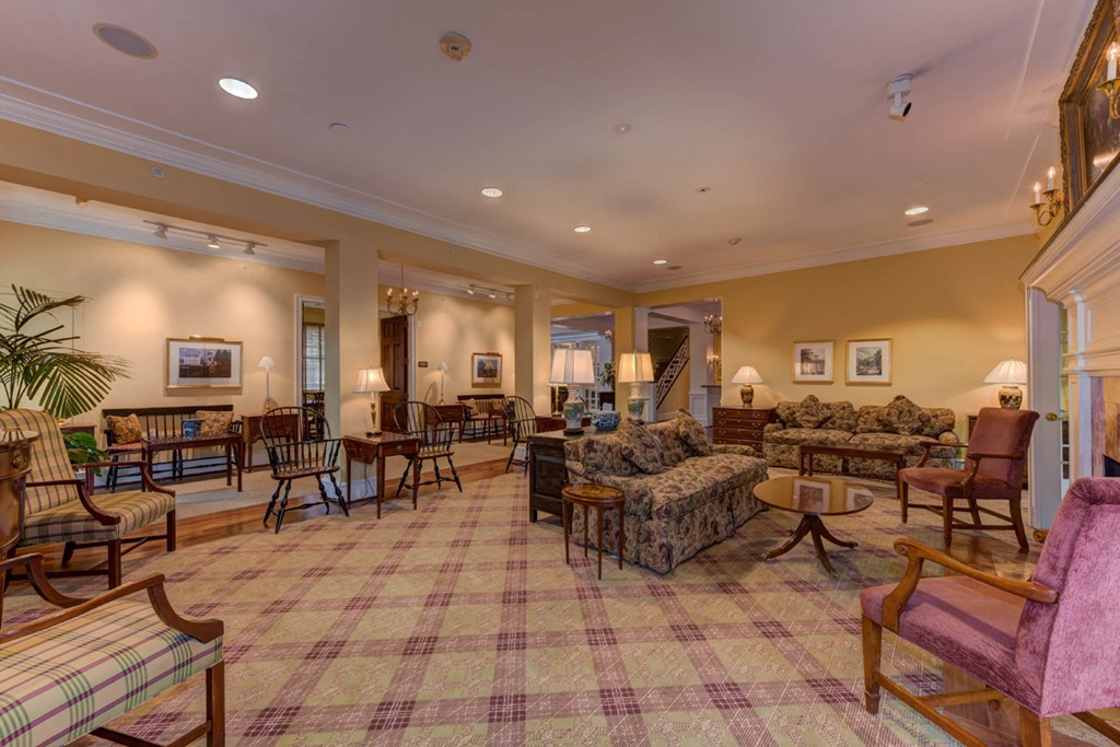 a living room with couches and chairs and a table with chairs