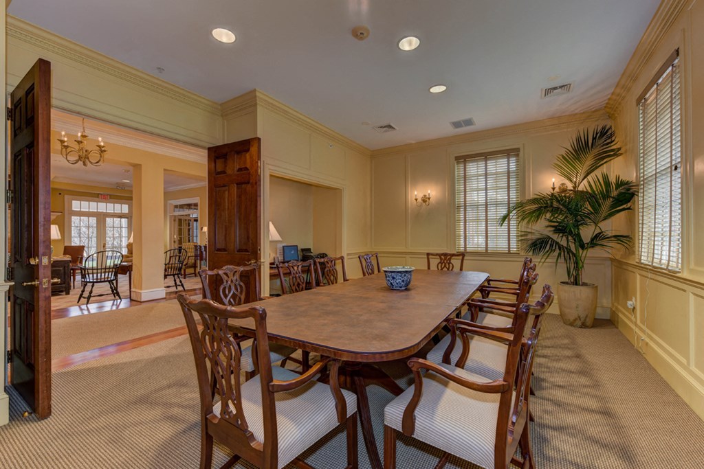 a large dining room with a large table and chairs