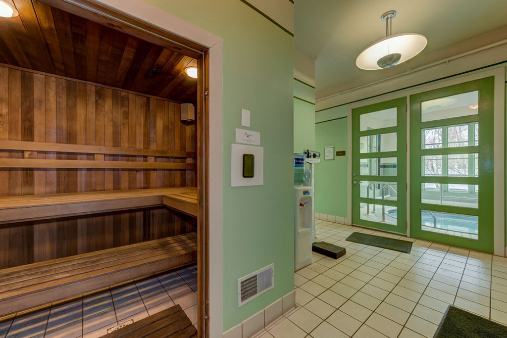 a room with a sauna and a mirror