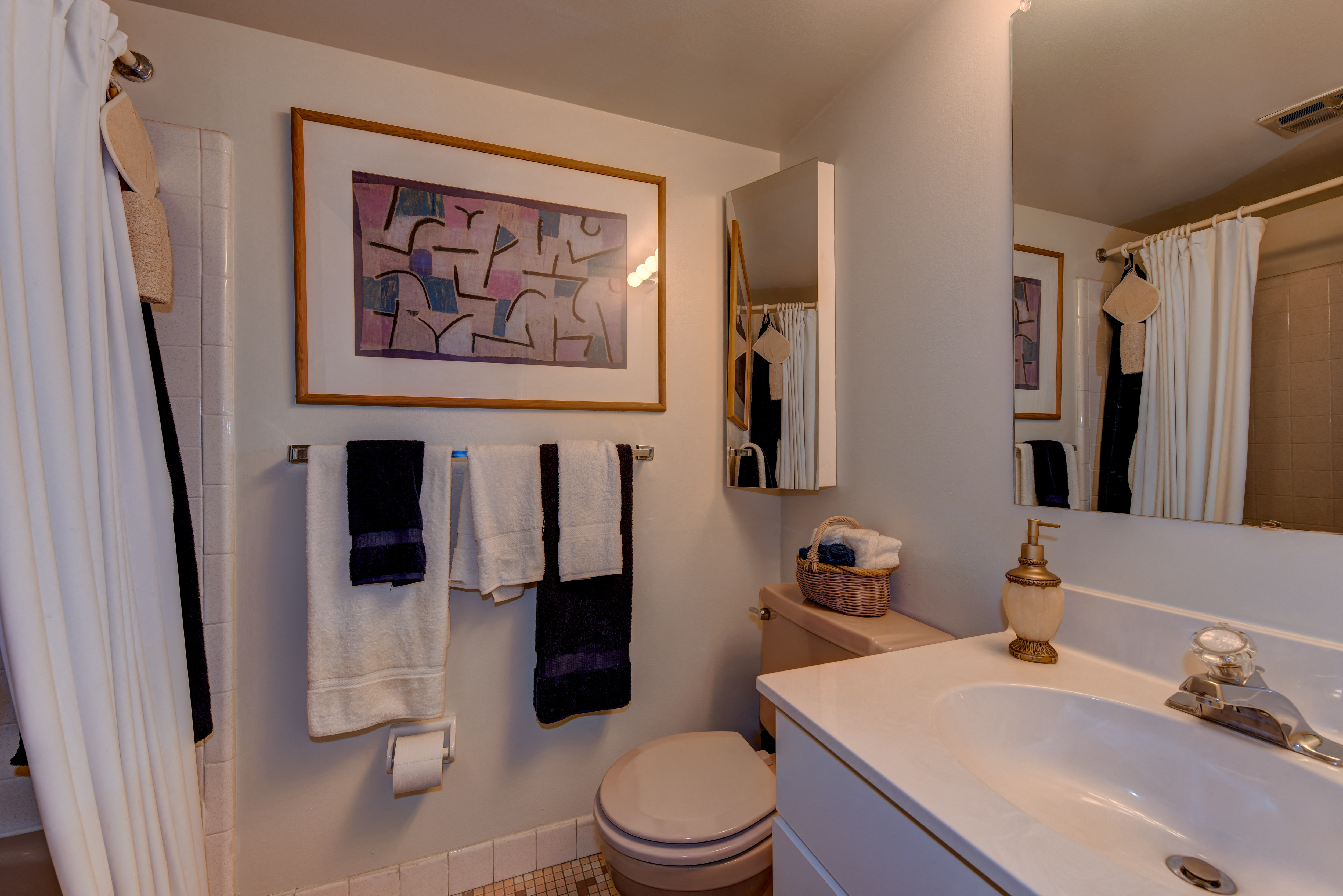 a bathroom with a sink toilet and shower and a mirror