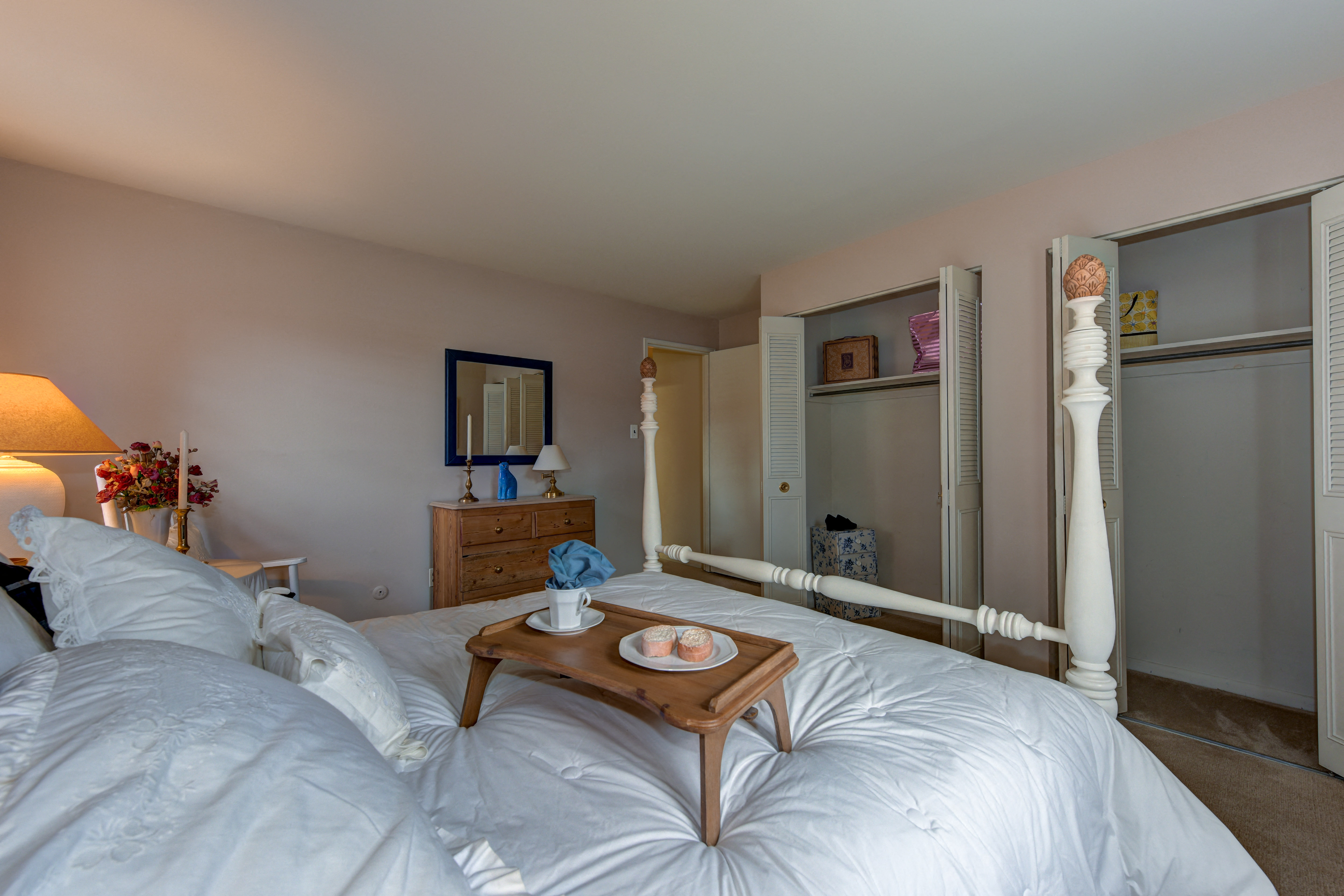 a bedroom with a large bed and a wooden table