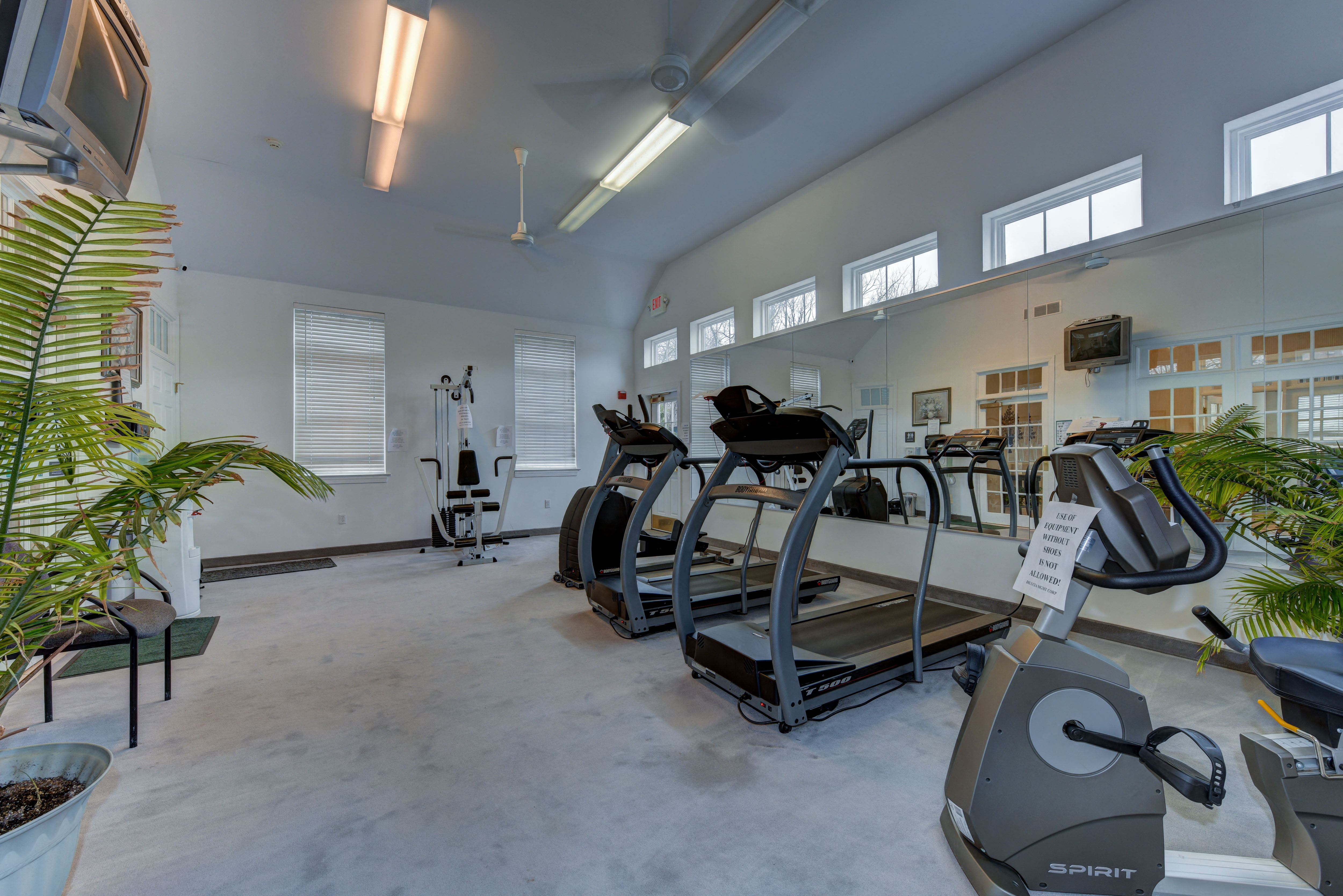 a gym with treadmills and other exercise equipment in a building