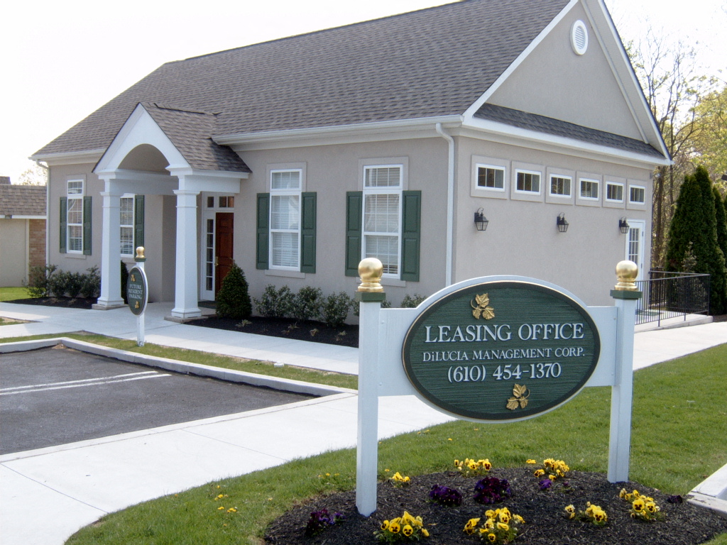 a leasing office sign in front of a house